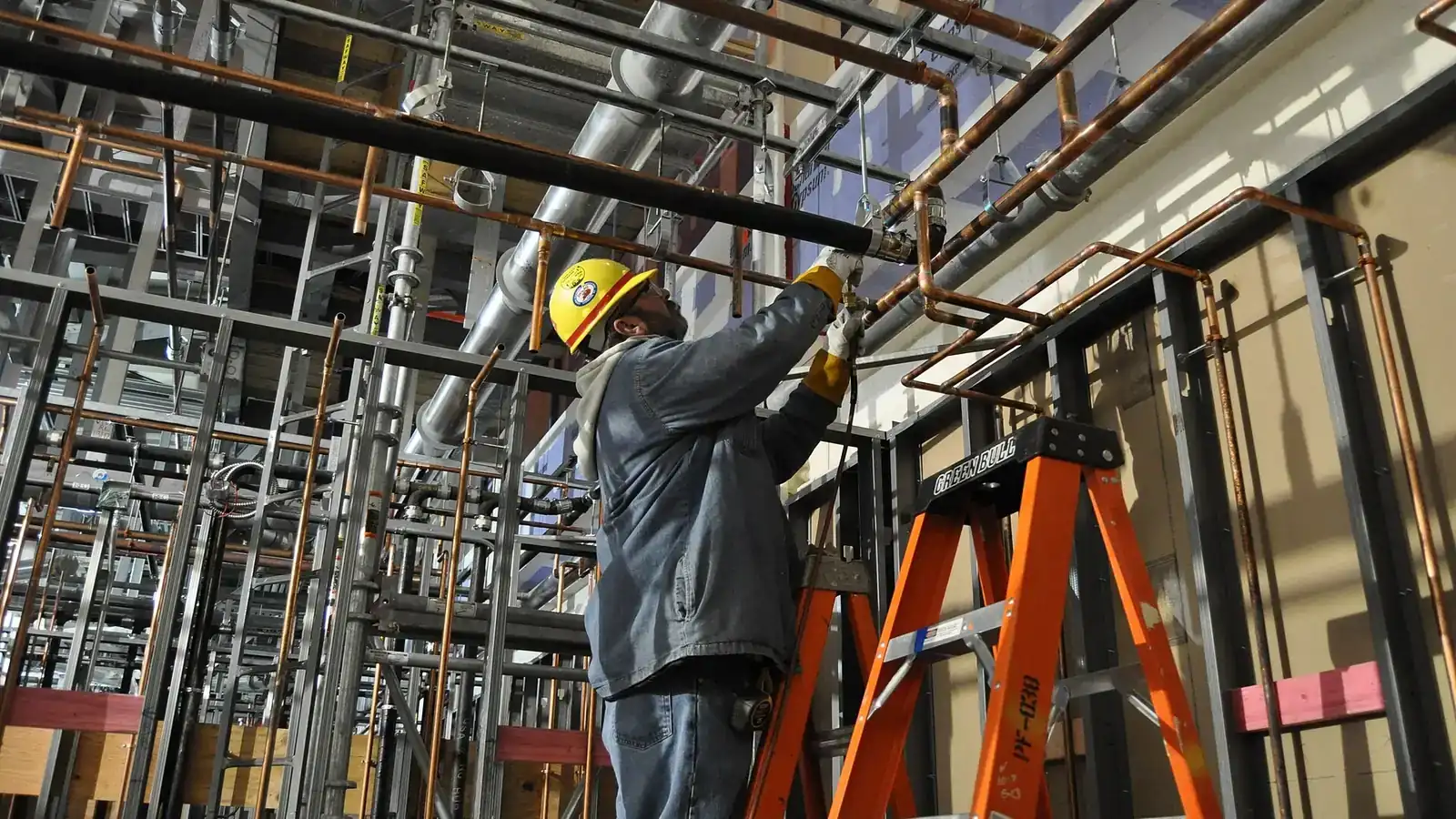 Maintenance technician inspecting pneumatic actuators in a plant