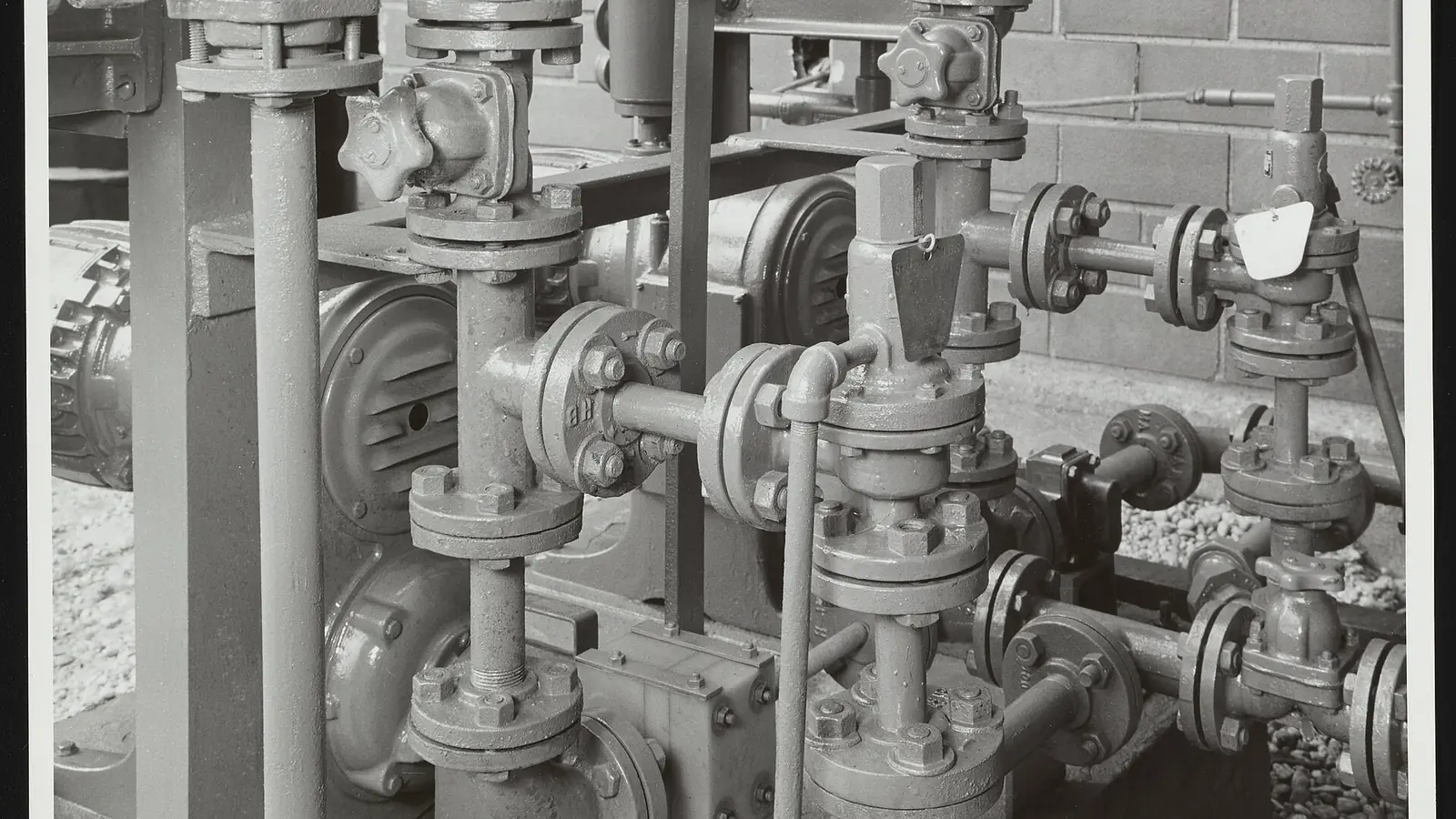 Automated valves aligned on a chemical plant pipe rack