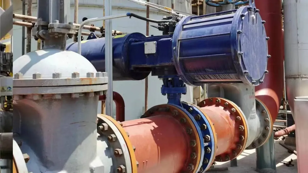 Large blue pneumatic actuator mounted on process piping