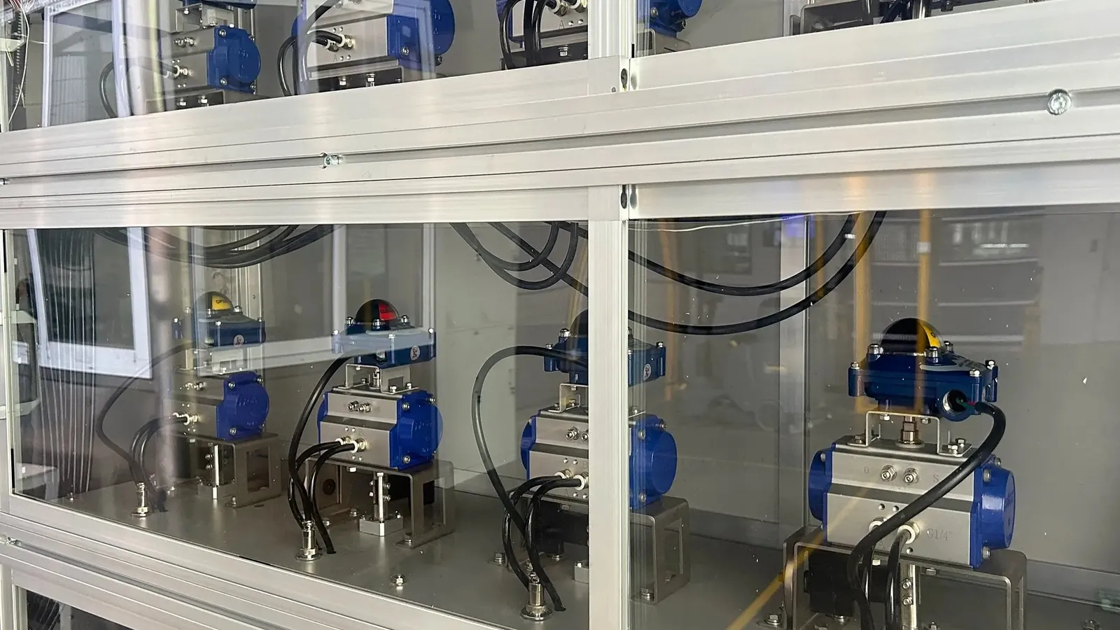 Rows of pneumatic quarter-turn actuators in a factory assembly area